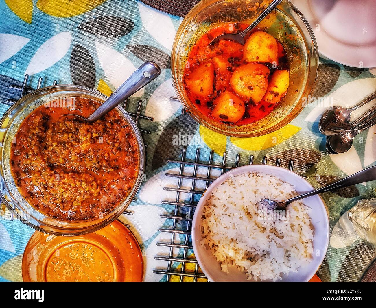 Elevated view of homemade Indian meal with mung dal, potato curry and rice Stock Photo