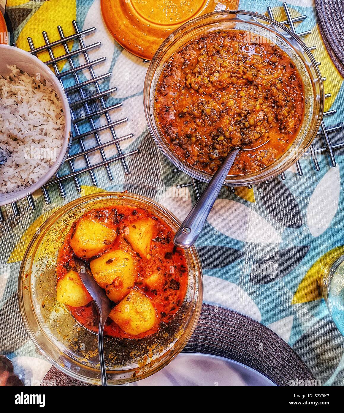 Elevated view of homemade Indian meal with rice, potato curry and mung dal Stock Photo