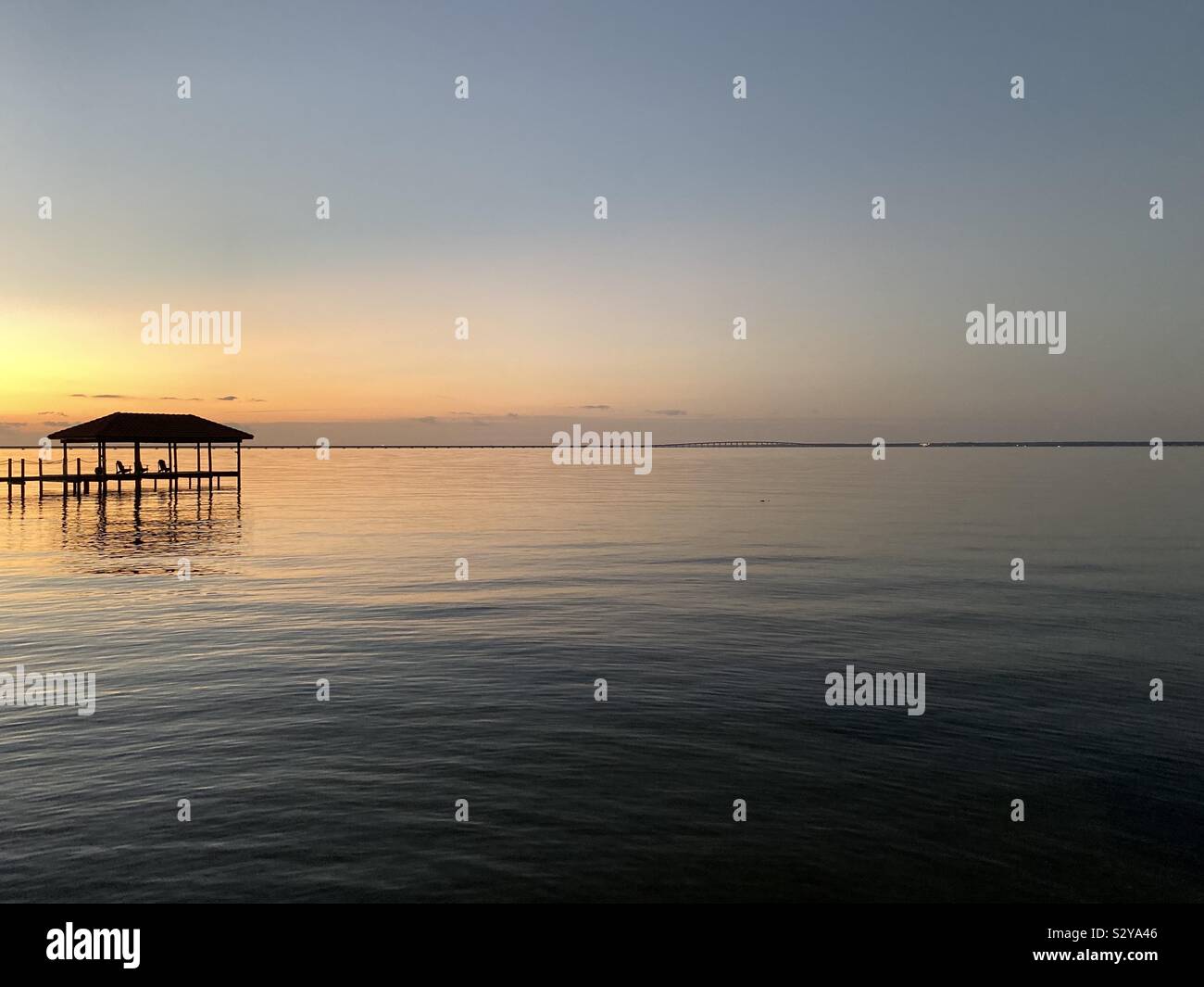 Colorful sunset skies over bay water Stock Photo - Alamy