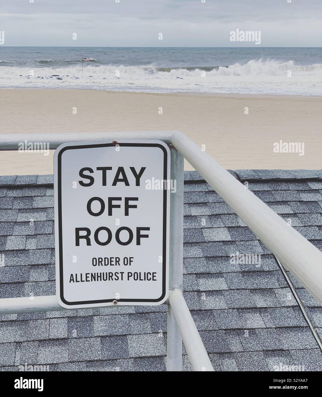 “Stay Off Roof” sign on the boardwalk over the Beach Club Cabanas, Allenhurst, Monmouth County, New Jersey, United States Stock Photo
