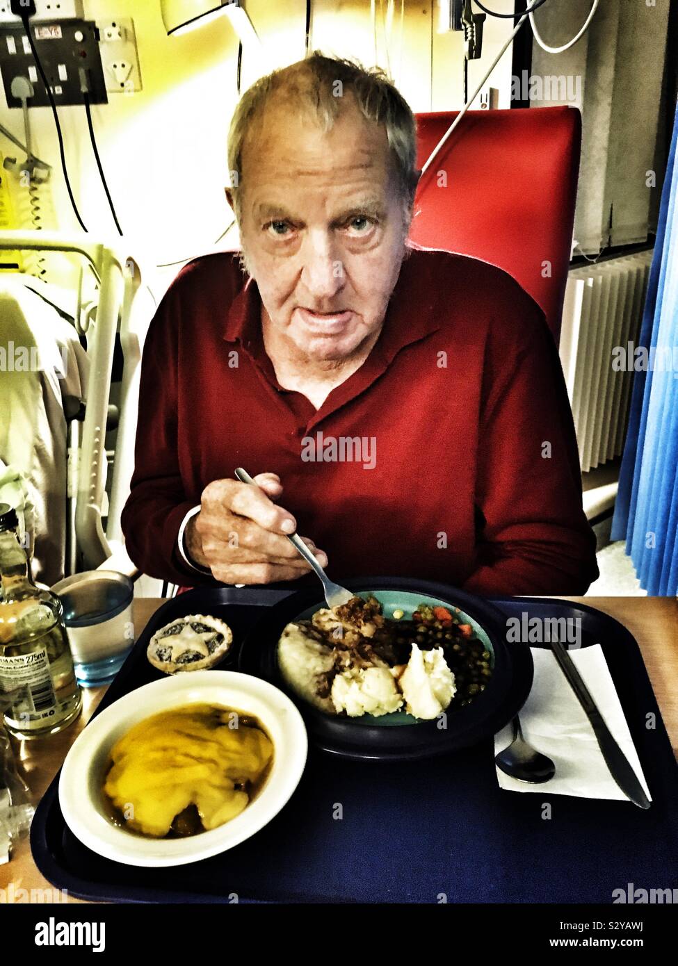 Elderly man eating hospital food - Smartphone Captured Stock Image