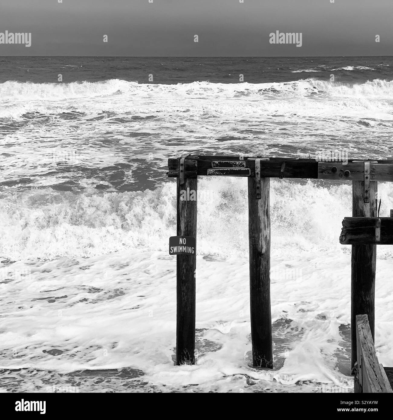 Black and white image of a part of Ocean Grove Fishing Pier, Ocean Grove, Neptune Township, Monmouth County, New Jersey, United States - Smartphone Captured Stock Image