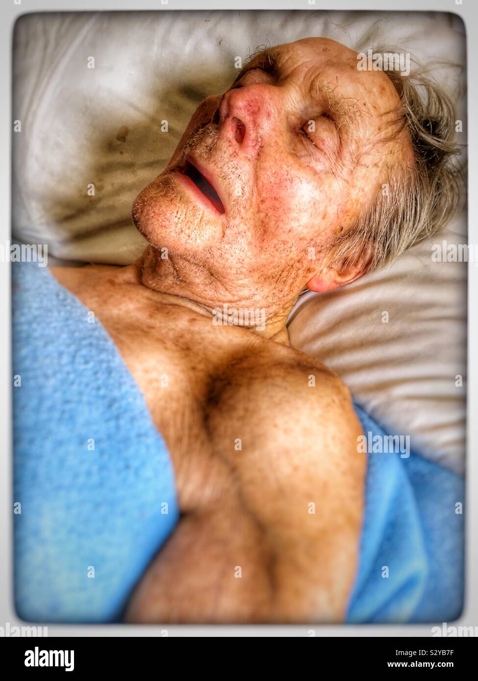 Old man asleep in bed - Smartphone Captured Stock Image