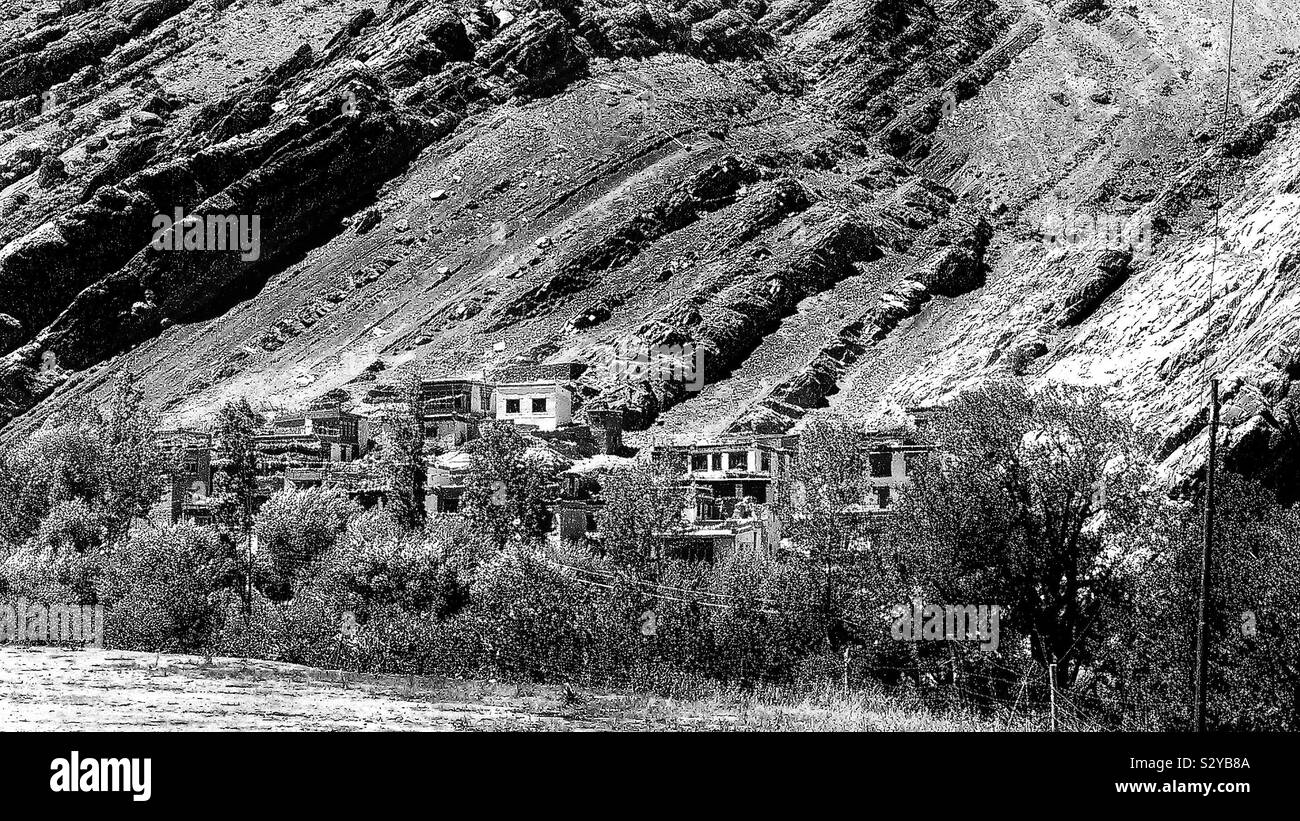 What a beautiful setting for a village, close by a river and so unreal in a hostile seeming environment people found a way to exist self sufficient and happy.Respect! Stock Photo