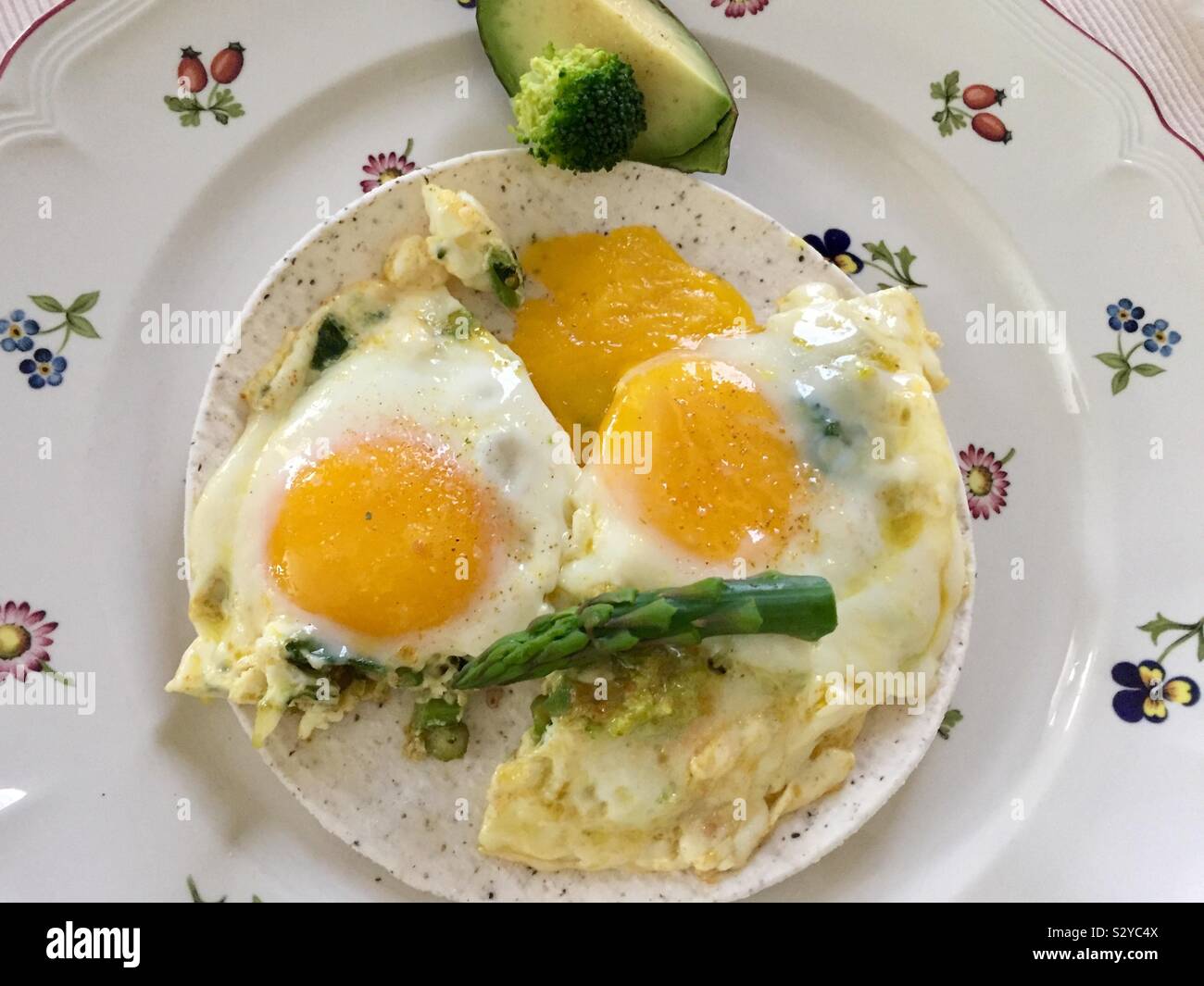 Coconut flour tortilla with sunny side up eggs Stock Photo