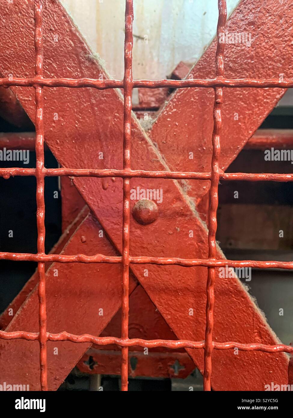 Solid structural steel x bracing covered with a heavy duty screen - Smartphone Captured Stock Image