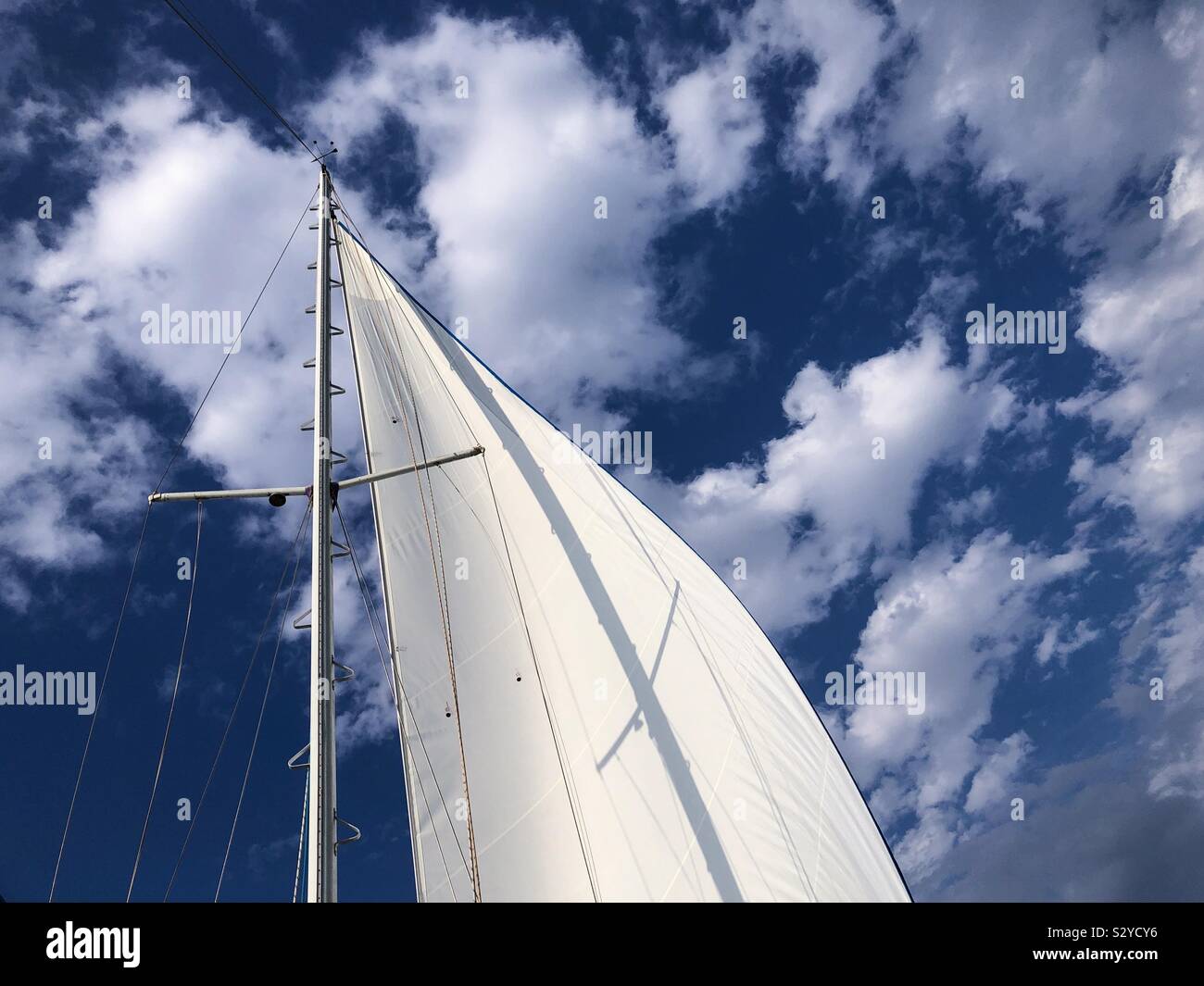 Sail of a sailboat against the sky. - Smartphone Captured Stock Image
