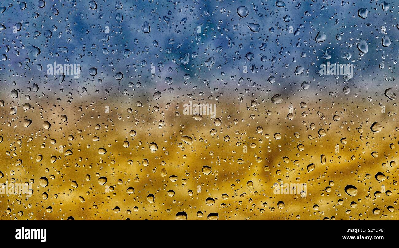 water droplets on glass with a colourful background Stock Photo