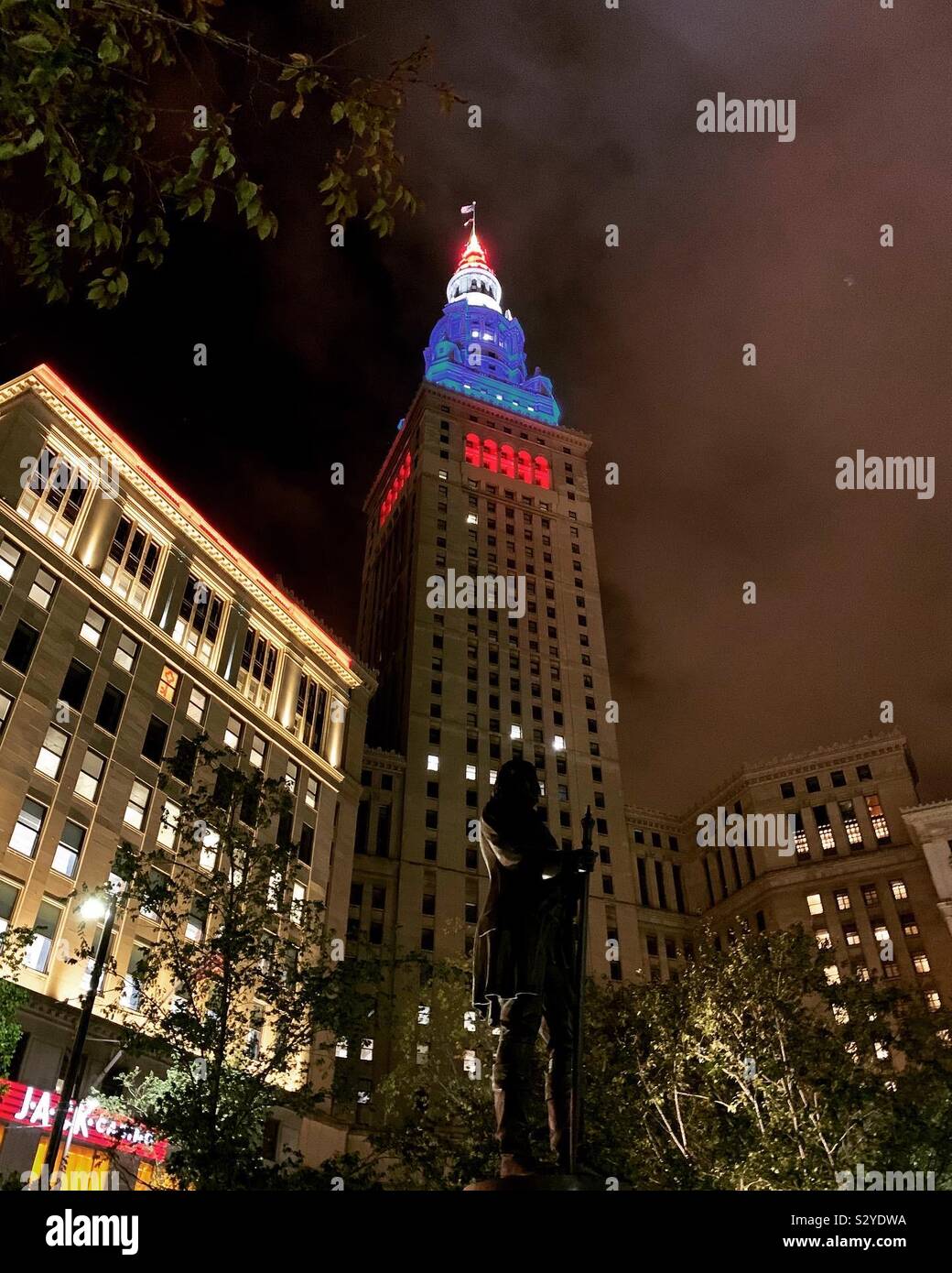 Downtown Cleveland Ohio at night; lit buildings and statues Stock Photo