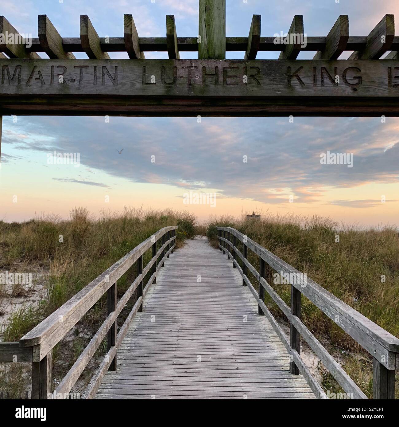 Sign over footbridge from Atlantic City Boardwalk to the beach indicates Martin Luther King Blvd. Many Atlantic City boulevards continue onto such pedestrian pathways. Atlantic City, New Jersey, USA - Smartphone Captured Stock Image