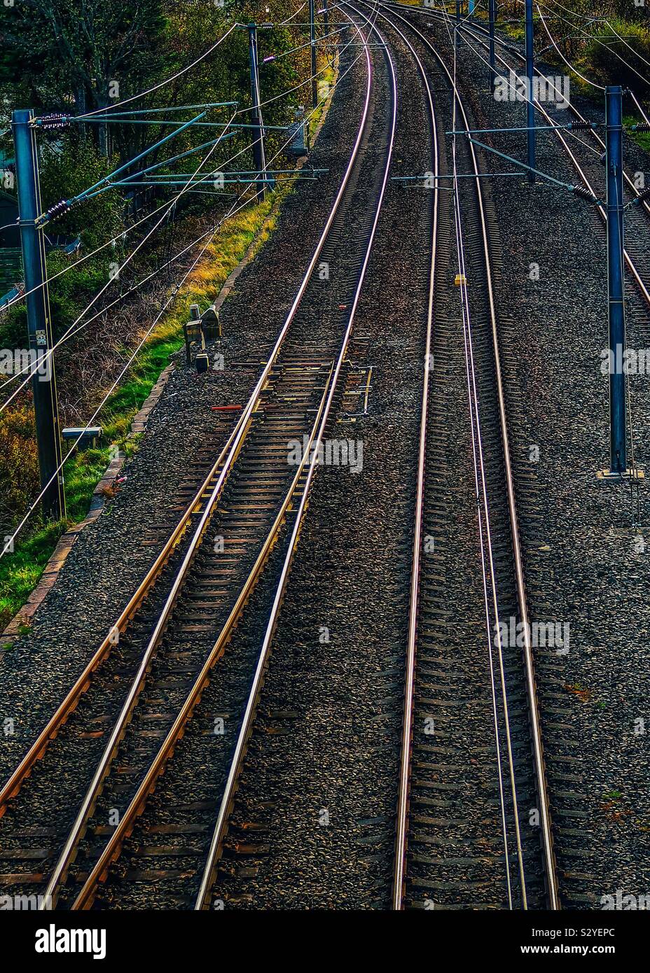 Railway track with electric overhead cables, Ayrshire, UK - Smartphone Captured Stock Image