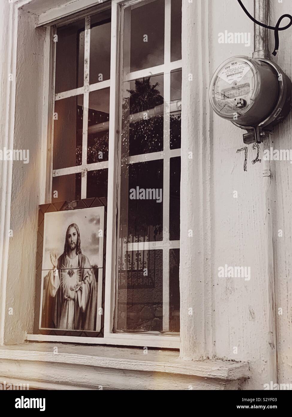 A picture of Jesus is displayed in a shop window in downtown Ajijic. Stock Photo