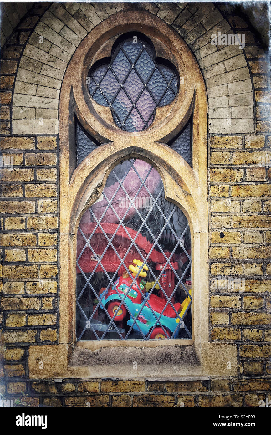 Children’s toys seen through a church window - Smartphone Captured Stock Image