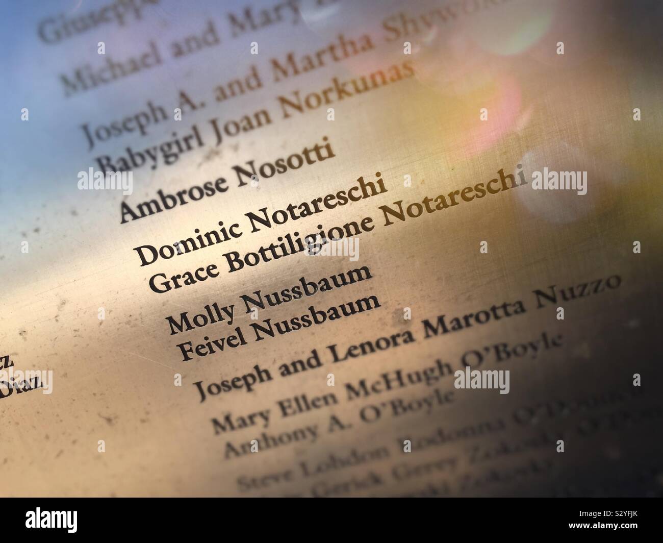 Close up of names of immigrants on the wall of honor at the Ellis