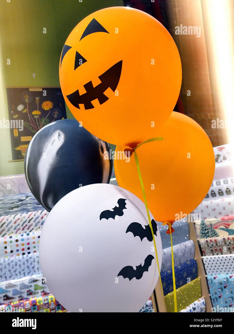 Halloween themed balloons featuring flying bats and jack-o’-lanterns, USA - Smartphone Captured Stock Image