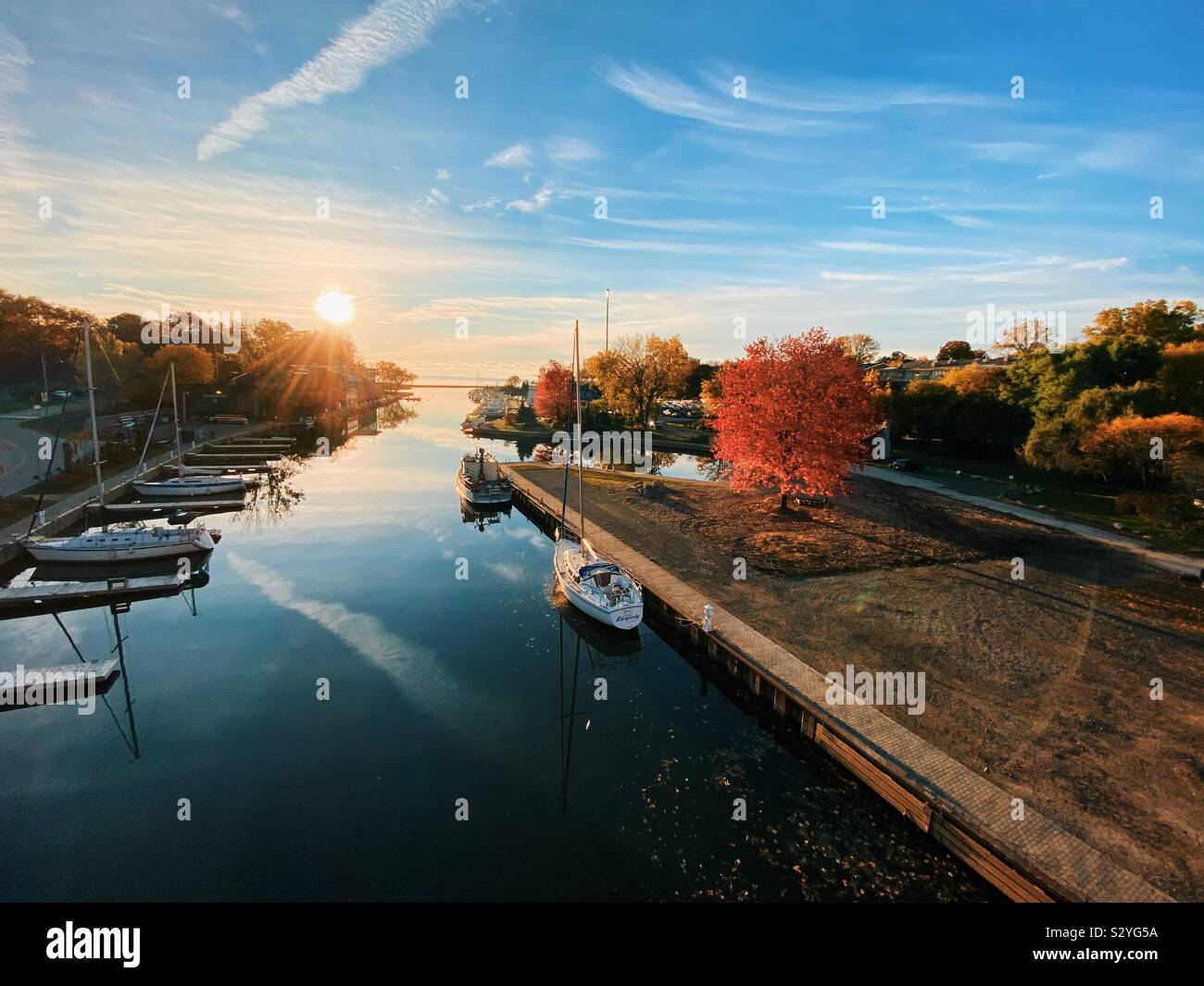 Oakville Ontario harbour in autumn October 2019. Sixteen mile creek out to Lake Ontario early morning sunrise. Stock Photo