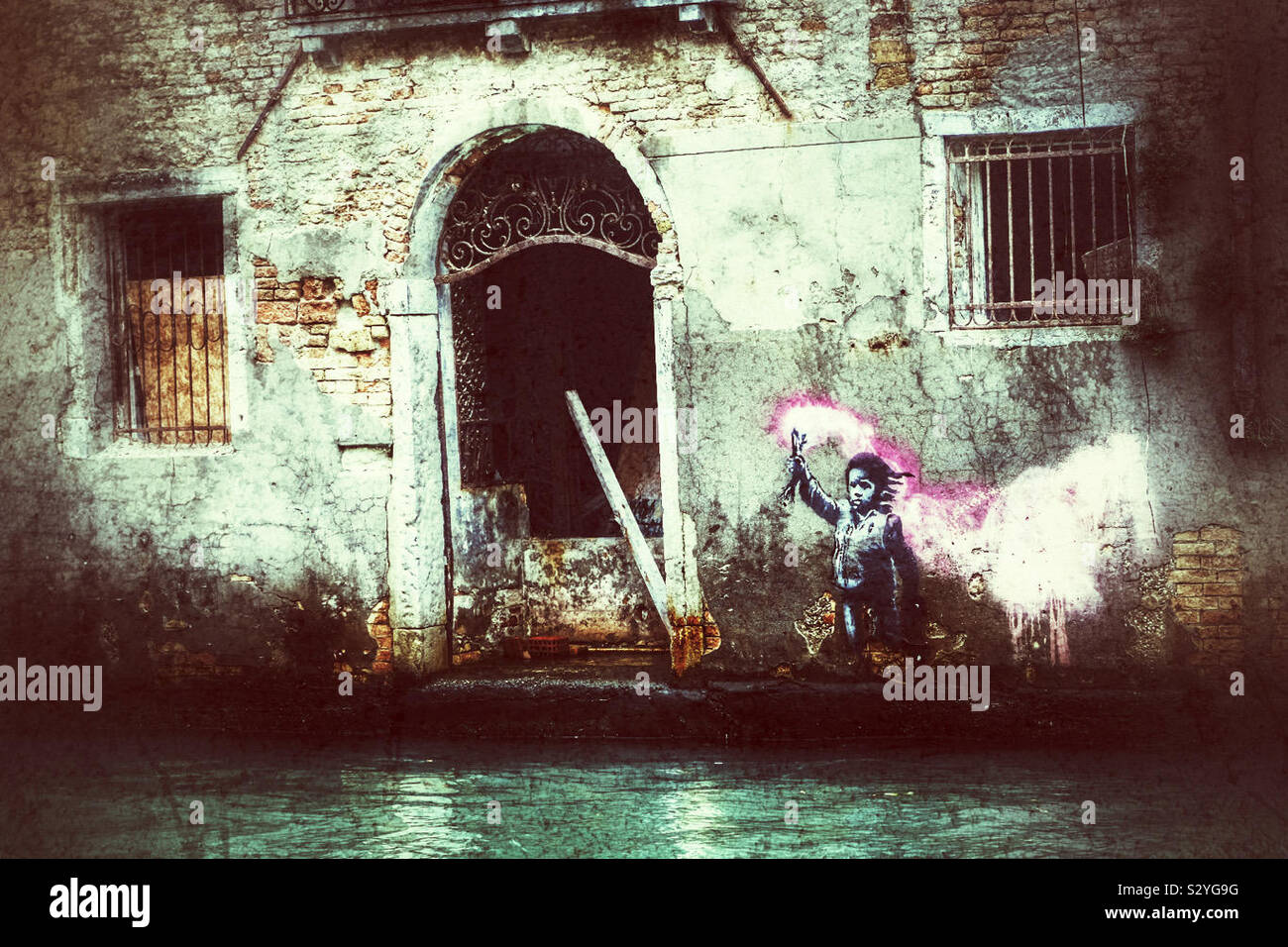Graffiti by the artist Banksy on the side of a house in Venice Italy - Smartphone Captured Stock Image