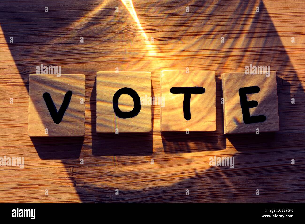 Vote. Word in 3D wooden alphabet letters on a bamboo wood background. Creative concept, government and politics. Stock Photo