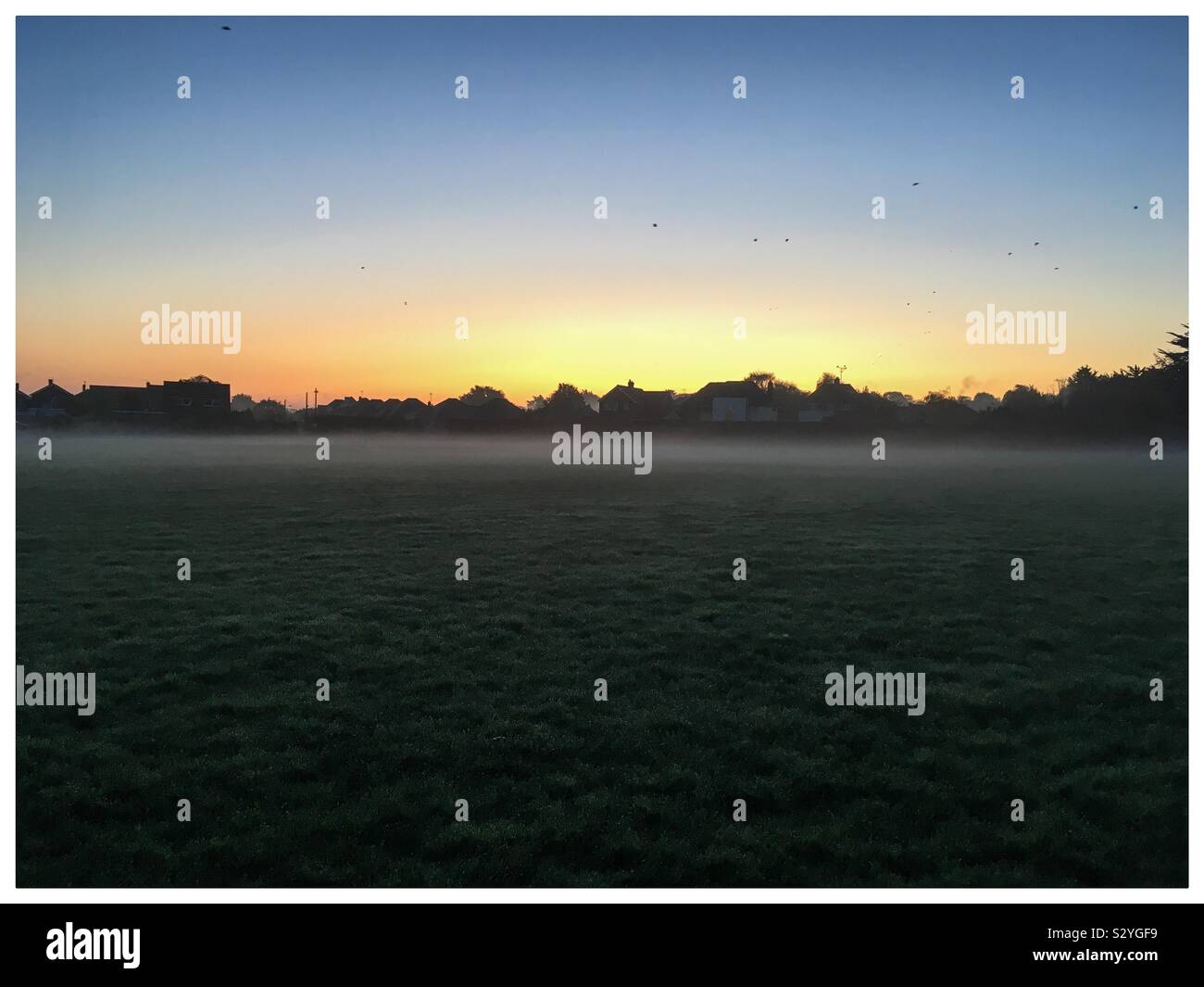Sunrise over the recreation ground with an autumn mist rising off the ground - Smartphone Captured Stock Image Sunrise over the recreation ground with an autumn mist rising off the ground - Smartphone Captured Stock Image