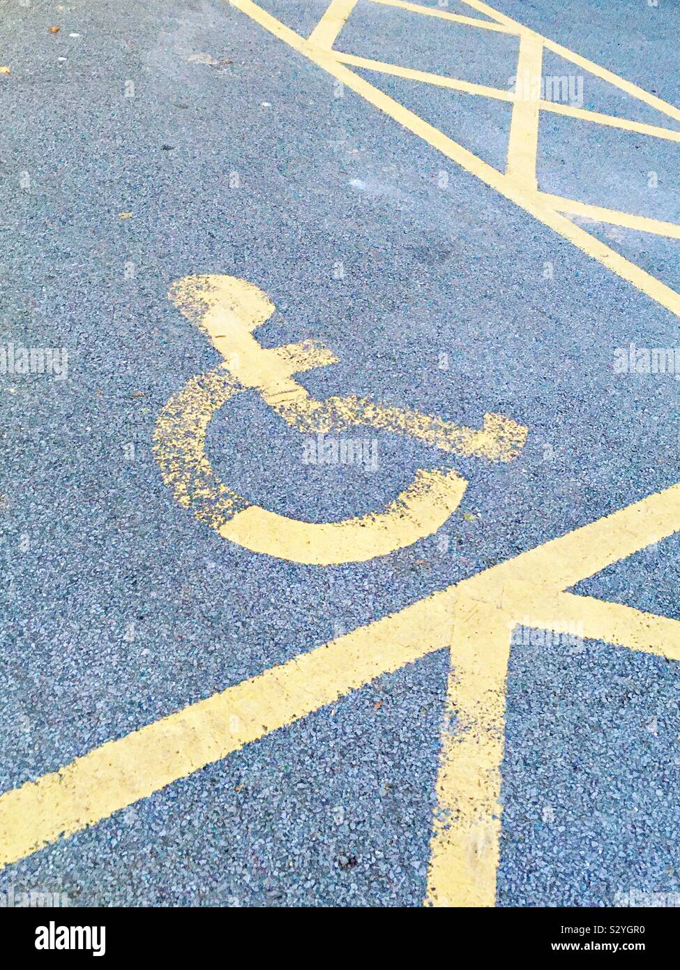 A disabled parking space in a car park Stock Photo