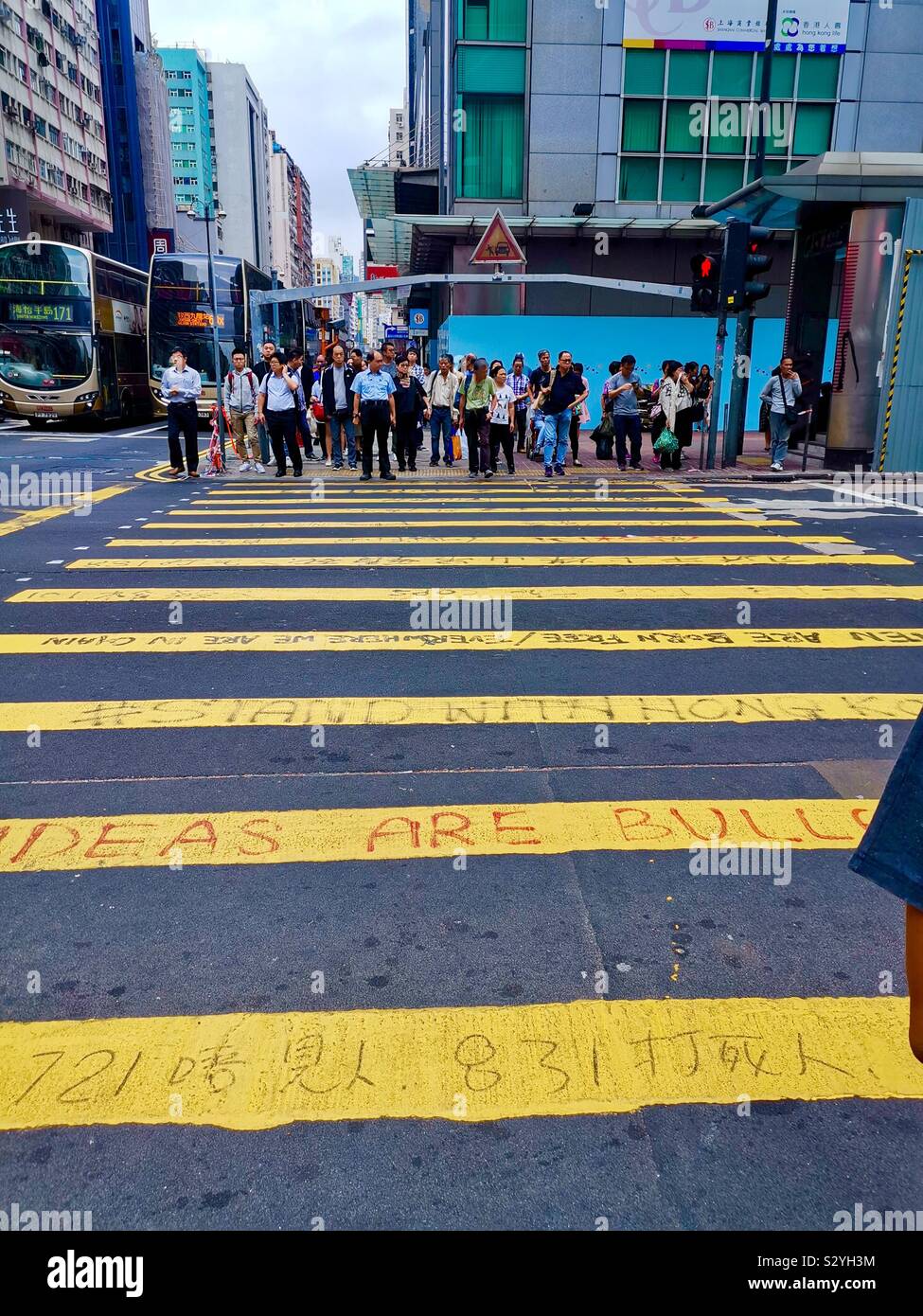 Pedestrian crossing full of political slogans during the 2019 political unrest in Hong Kong. - Smartphone Captured Stock Image