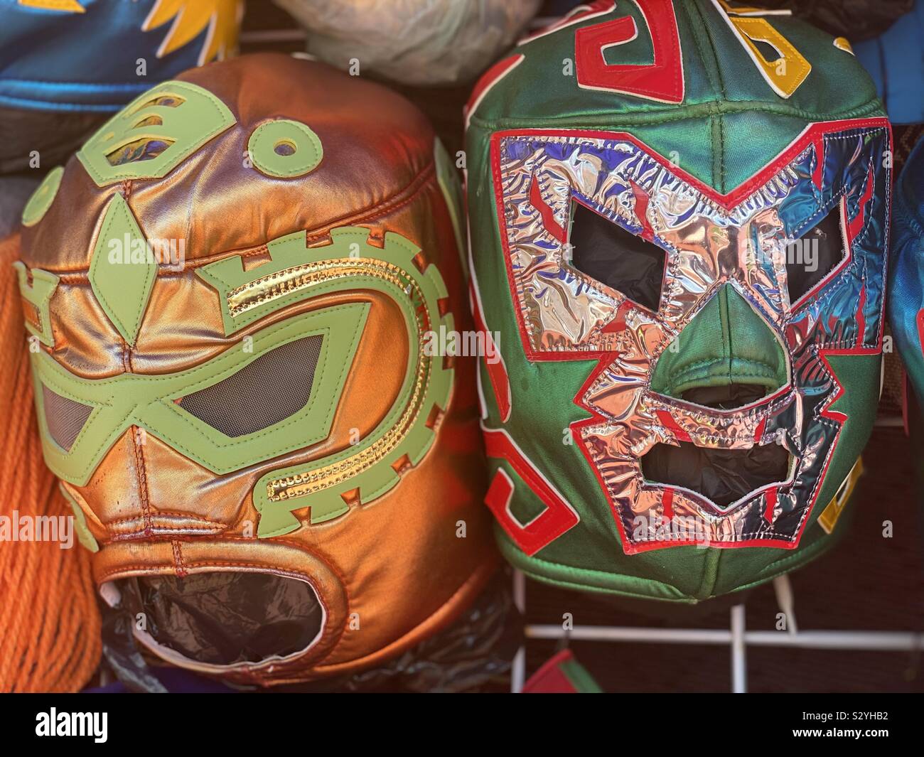 Mexican wrestler masks hanging in a stall waiting to be bought Stock Photo