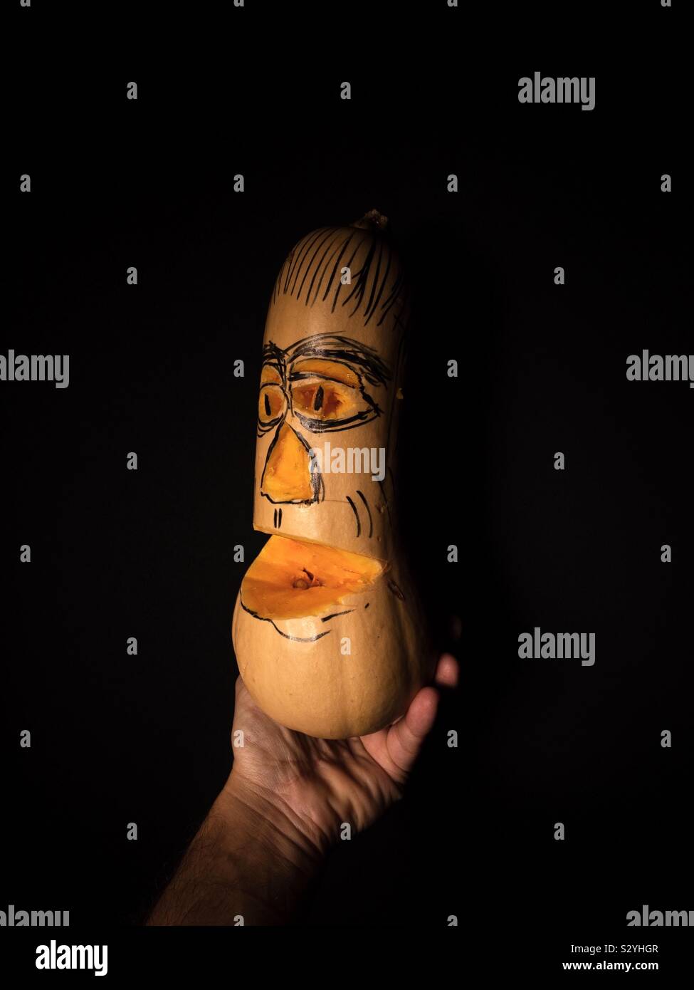 Man holding a Carved butternut squash Stock Photo