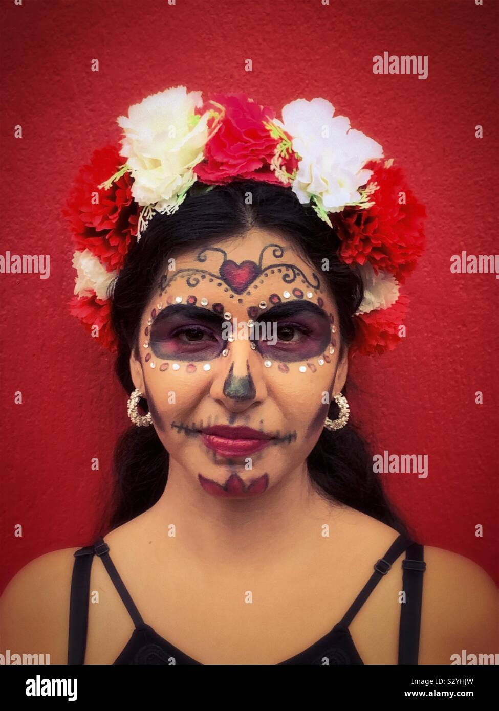 A young woman with her face painted like a catrina dresses up for a Halloween party in Ajijic, Mexico. Stock Photo