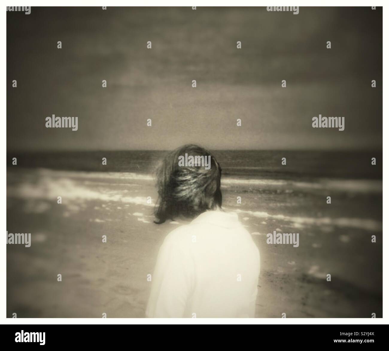 Rear view of a woman at the beach. - Smartphone Captured Stock Image