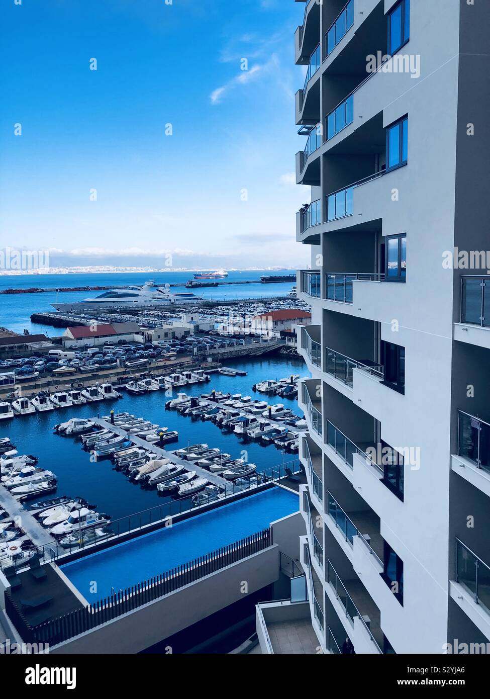 Apartment building overlooking boats and the sea - Smartphone Captured Stock Image