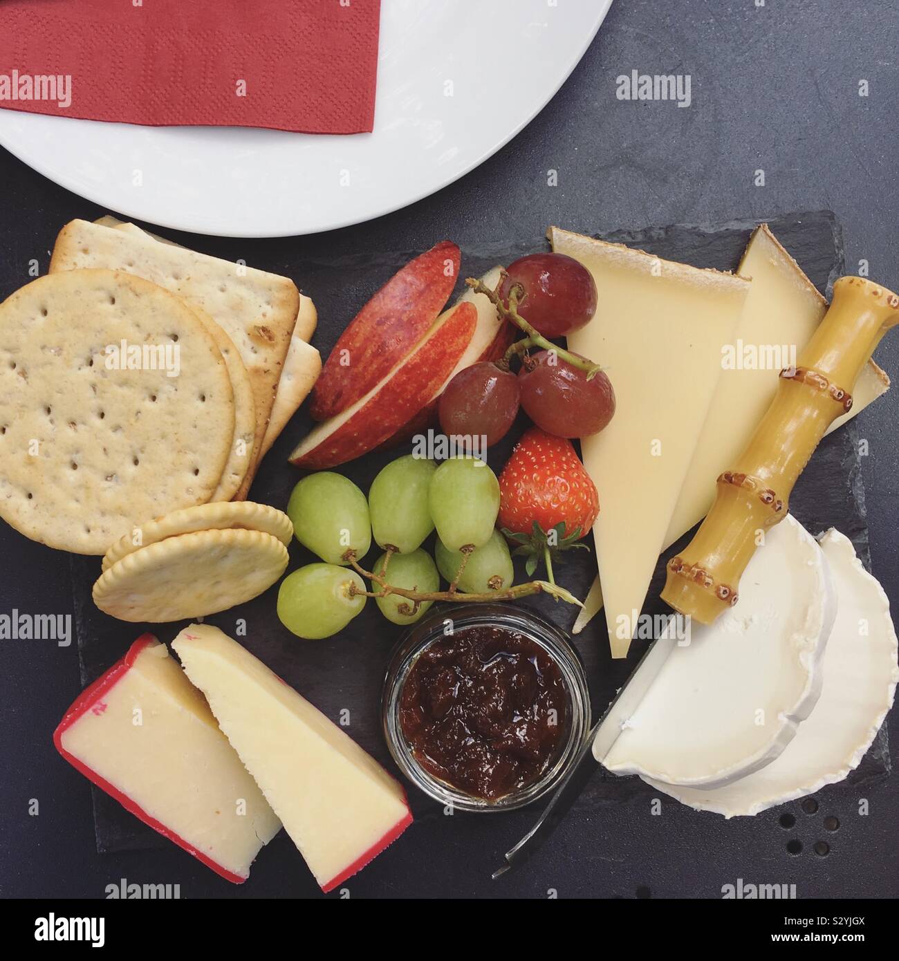 Cheese platter selection with grapes  chutney and cheese biscuit Stock Photo