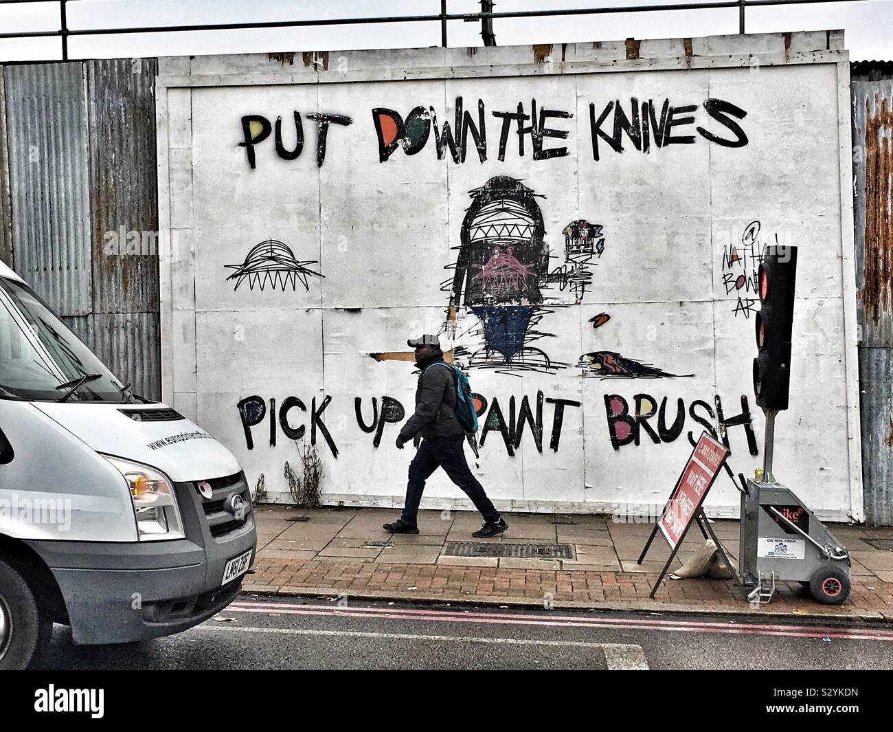 Put down the knives pick up a pain brush mural in Bellingham, London, England - Smartphone Captured Stock Image