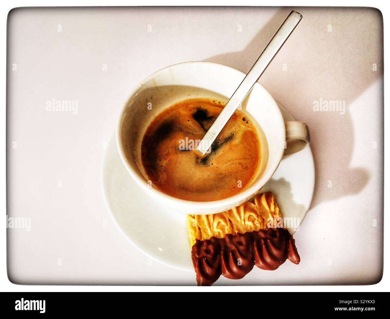 Black coffee and Dutch shortbread biscuit - Smartphone Captured Stock Image