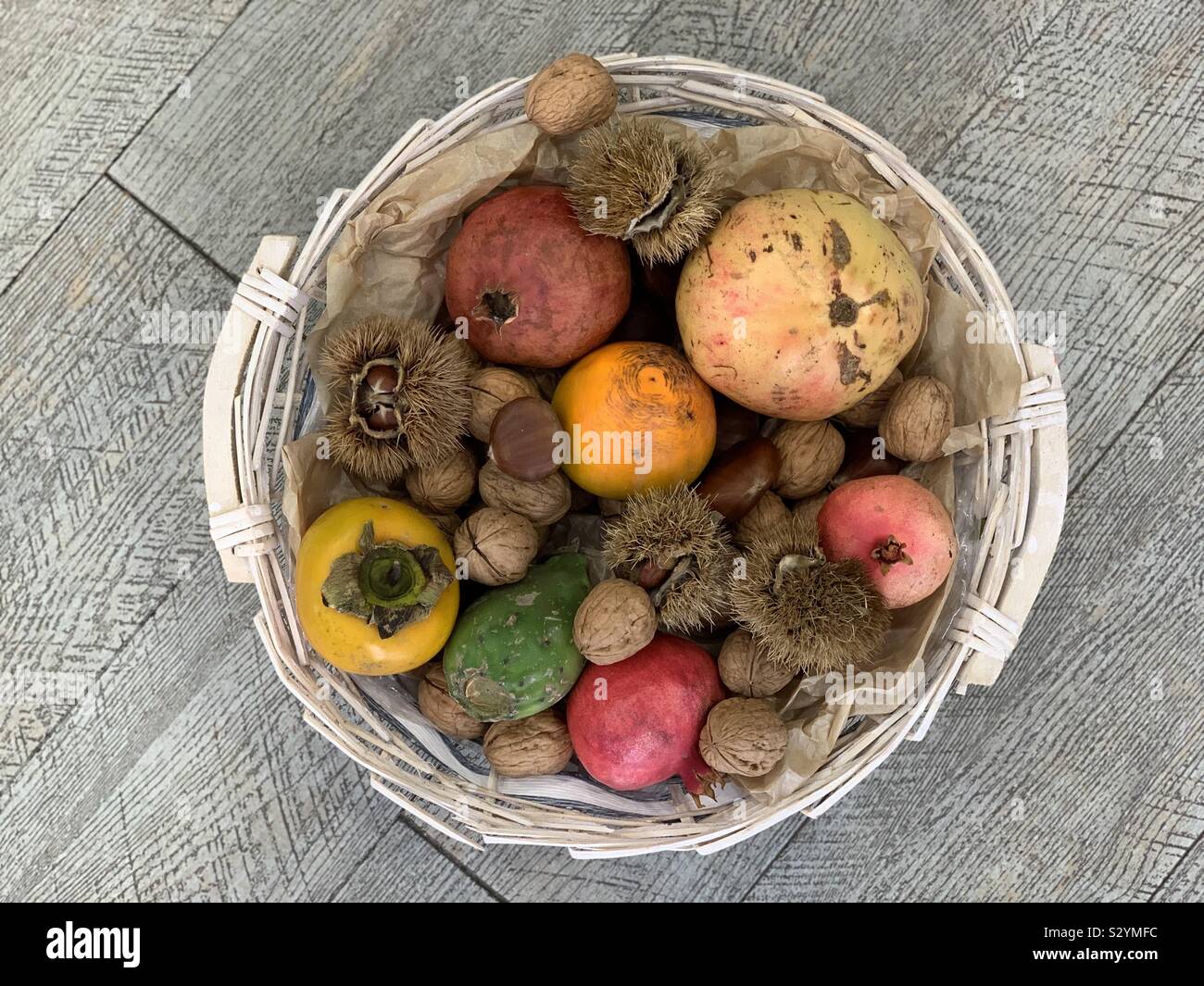 Autumn basket with typical seasonal fruits Stock Photo
