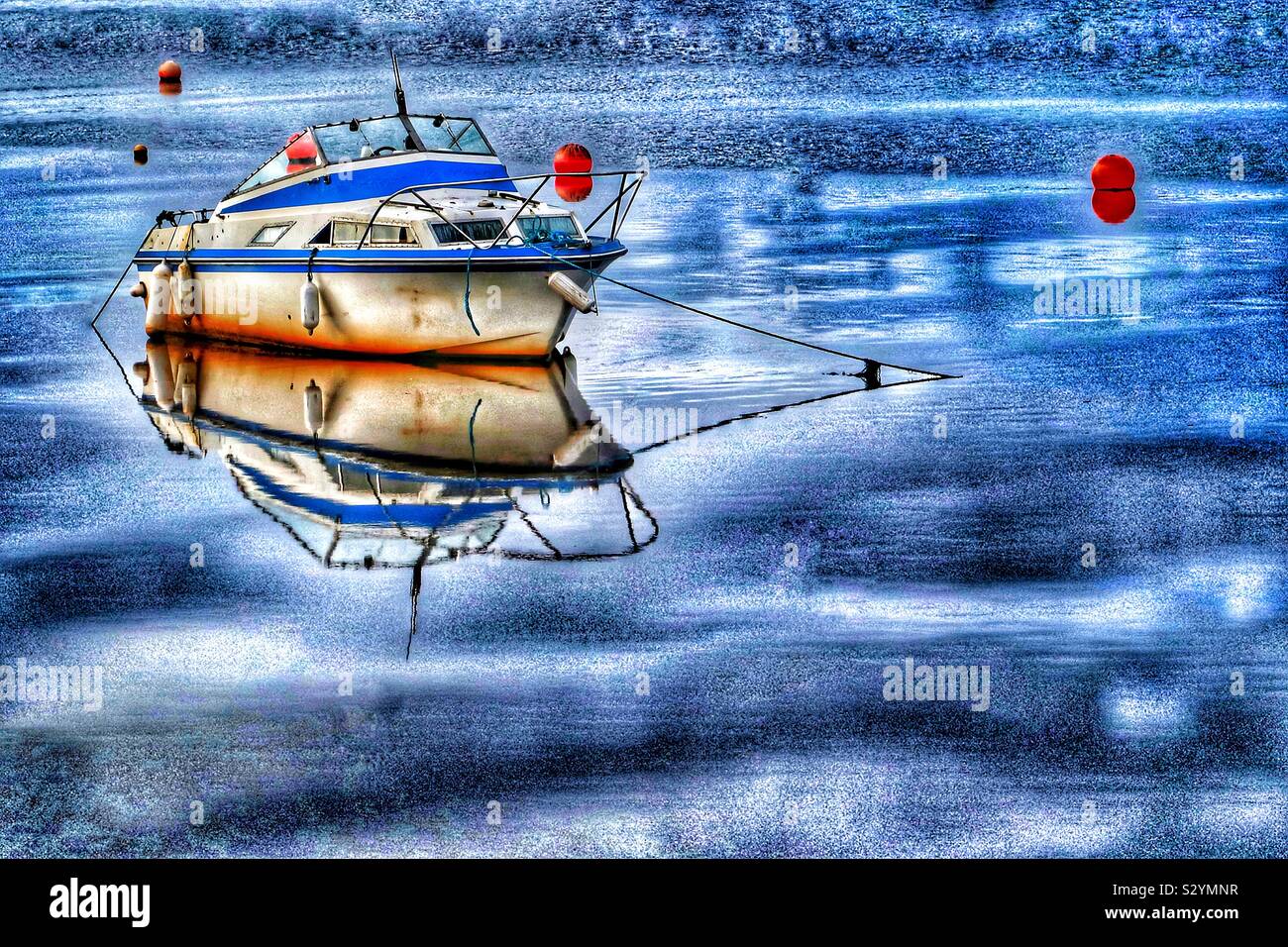 small motor boat tied to a buoy in Irvine harbour, Ayrshire, Scotland, UK - Smartphone Captured Stock Image