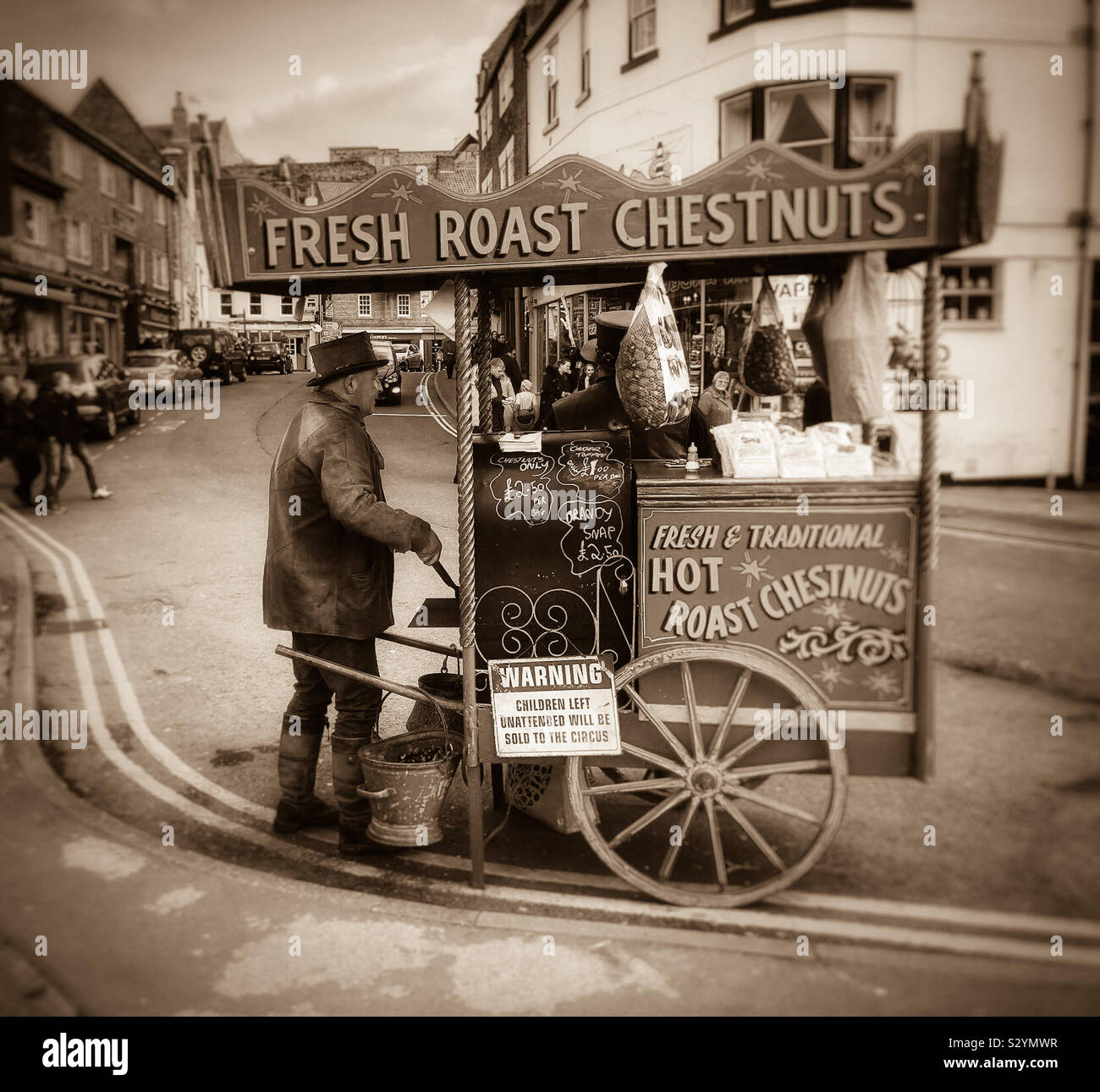 Sepia image of a street vendor selling hot, roast chestnuts - Smartphone Captured Stock Image