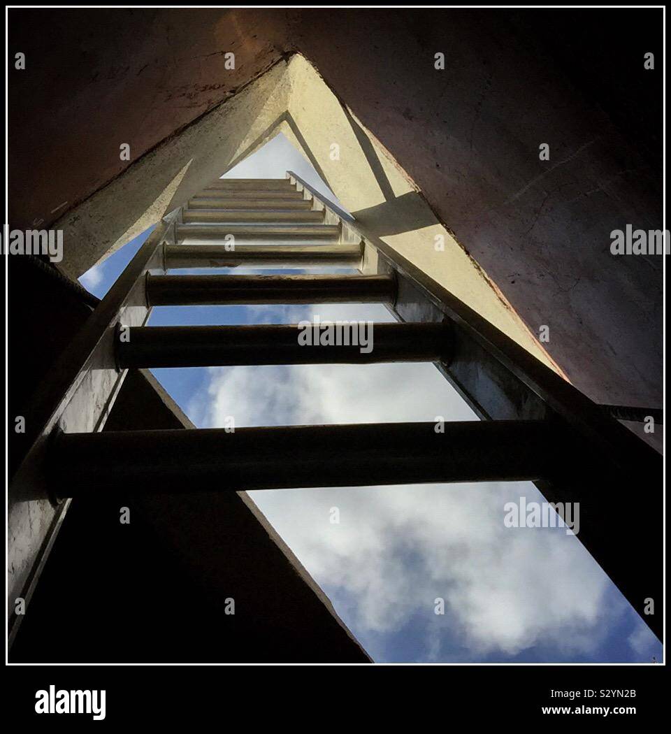 A ladder stretching skyward from below ground, Catalonia, Spain. - Smartphone Captured Stock Image