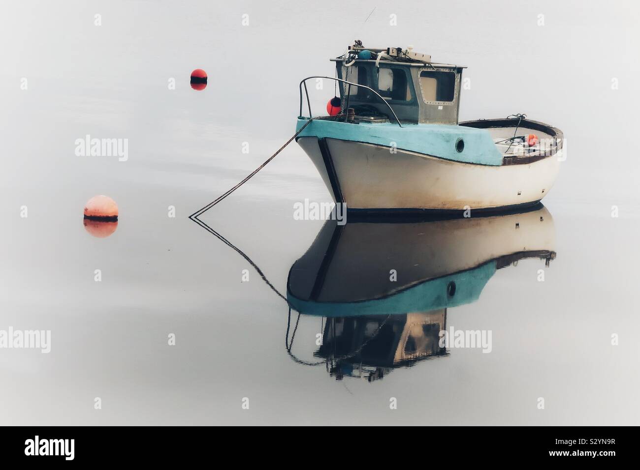Small boat in soft morning light, Irvine harbour, Ayrshire, Scotland, UK - Smartphone Captured Stock Image