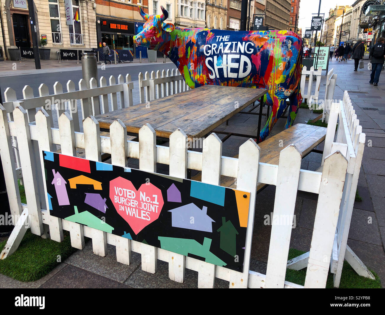 Cardiff, Wales, UK: 22 October 2019 - A painted cow advertises The Grazing Shed burger restaurant. Stock Photo