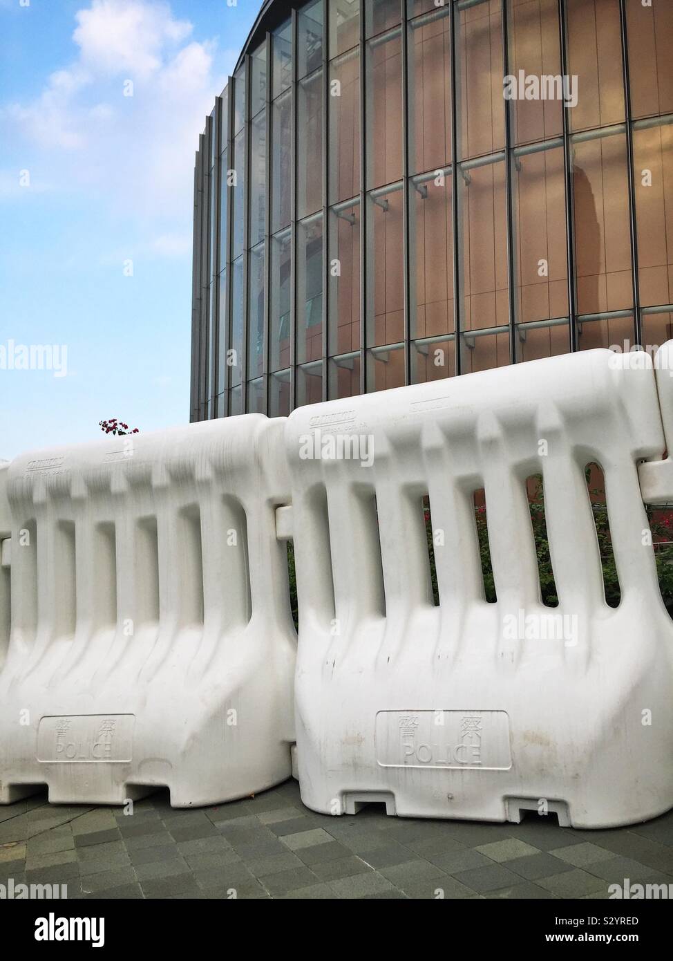 The new face of Hong Kong: the Legislative Council building barricaded behind 2-meter high water-filled barriers during the protests in October 2019 - Smartphone Captured Stock Image