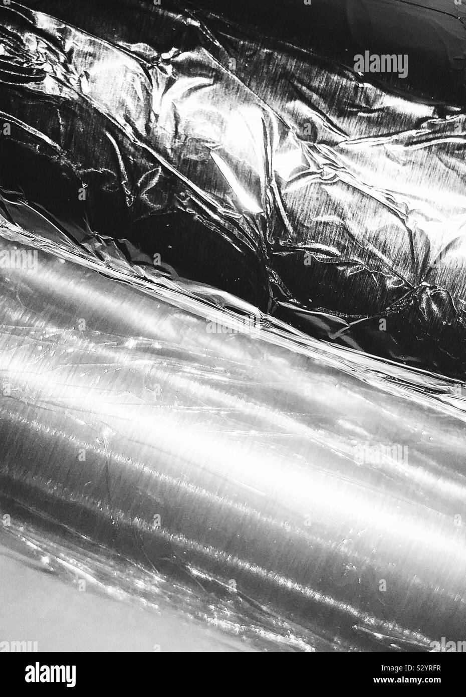 https://c8.alamy.com/comp/S2YRFR/closeup-photo-in-black-and-white-of-kitchen-foil-and-cling-film-on-rolls-S2YRFR.jpg