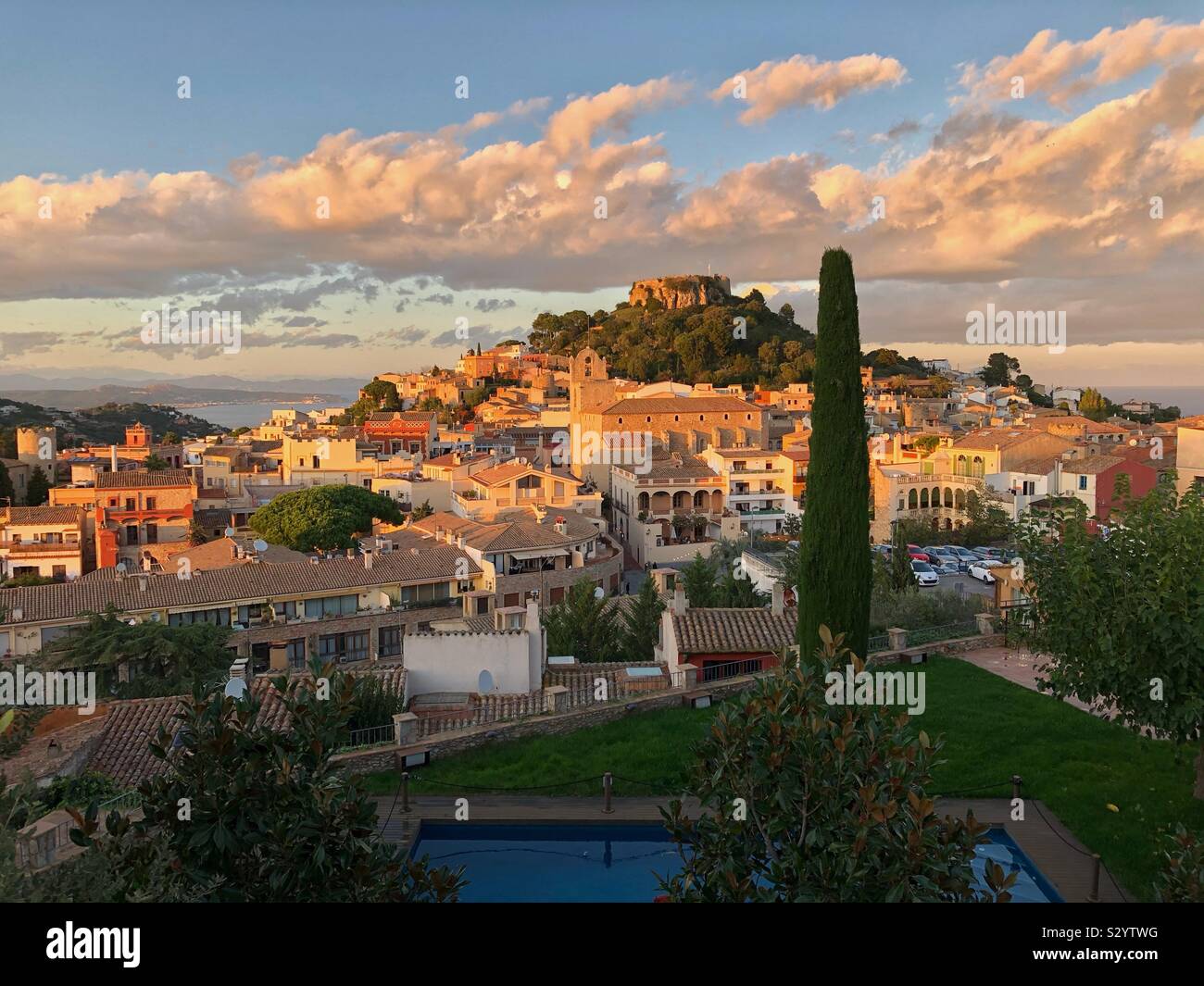 The castle ruins sitting high above the old town of Begur in Catalunya, Spain, basking in late afternoon November sunlight. Stock Photo