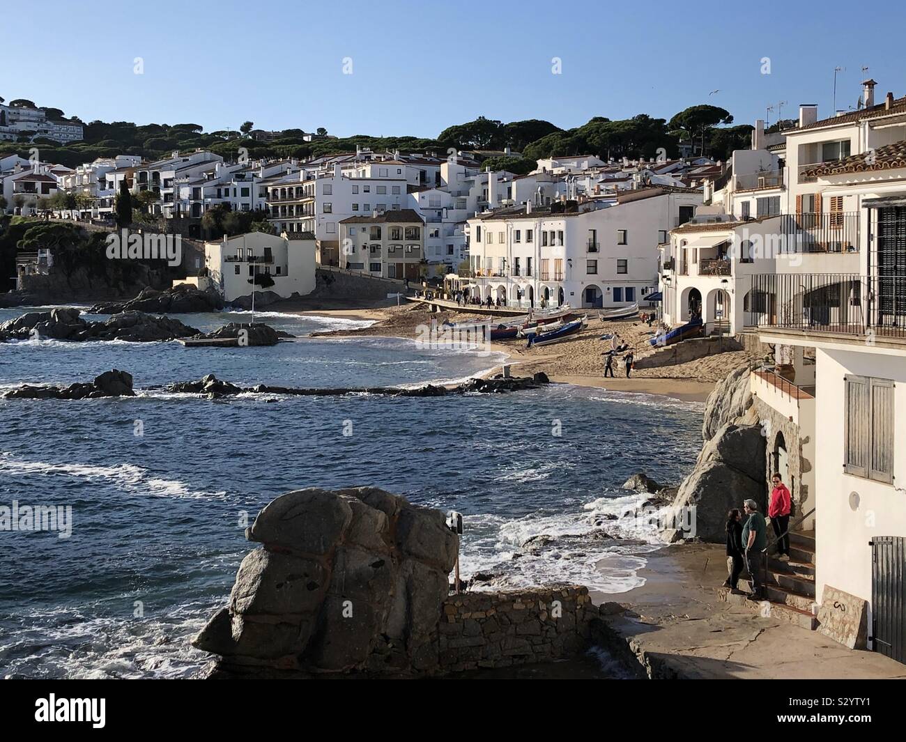 Canadell beach and Calella de Palafrugell town, Costa Brava in Spain, basking in autumn afternoon sunshine. - Smartphone Captured Stock Image