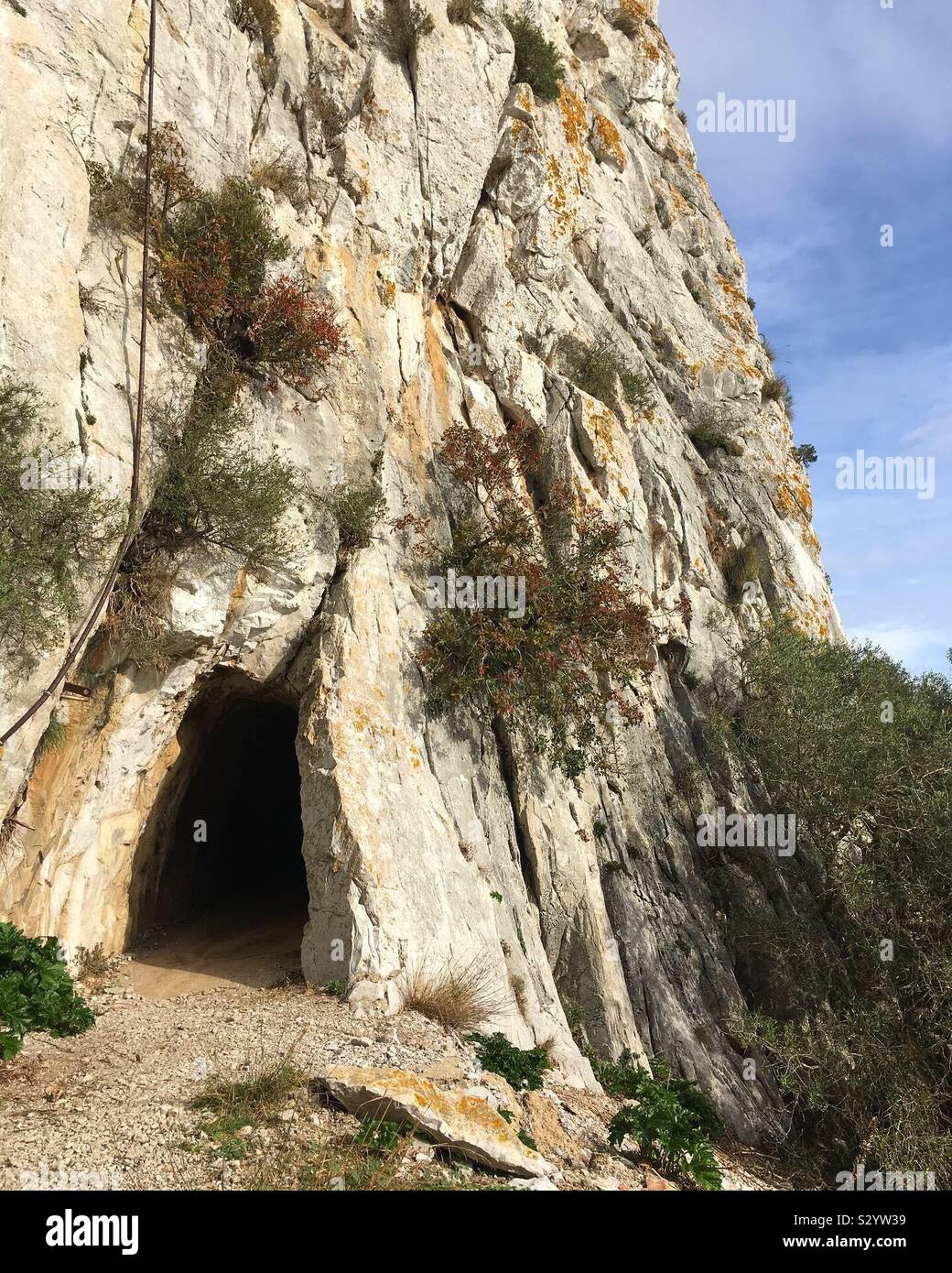 Tunnel entrance on a cliff walk on Gibraltar Rock, the Mediterranean Steps. Stock Photo