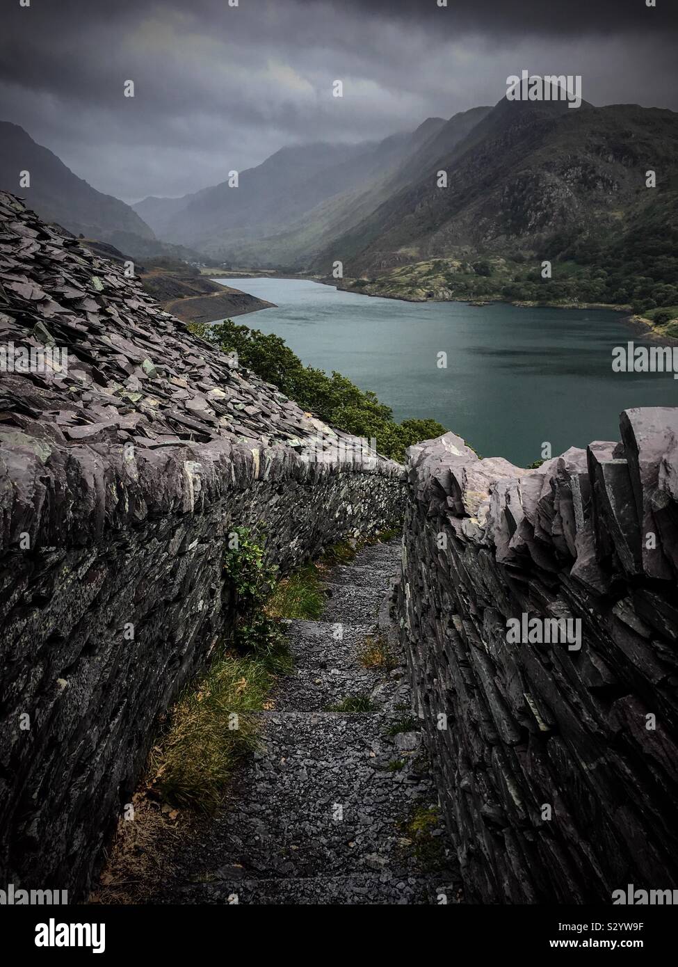 Dinorwic Quarry in moody stormy conditions overlooking Llyn Peris in Snowdonia National Park, Wales, UK Stock Photo