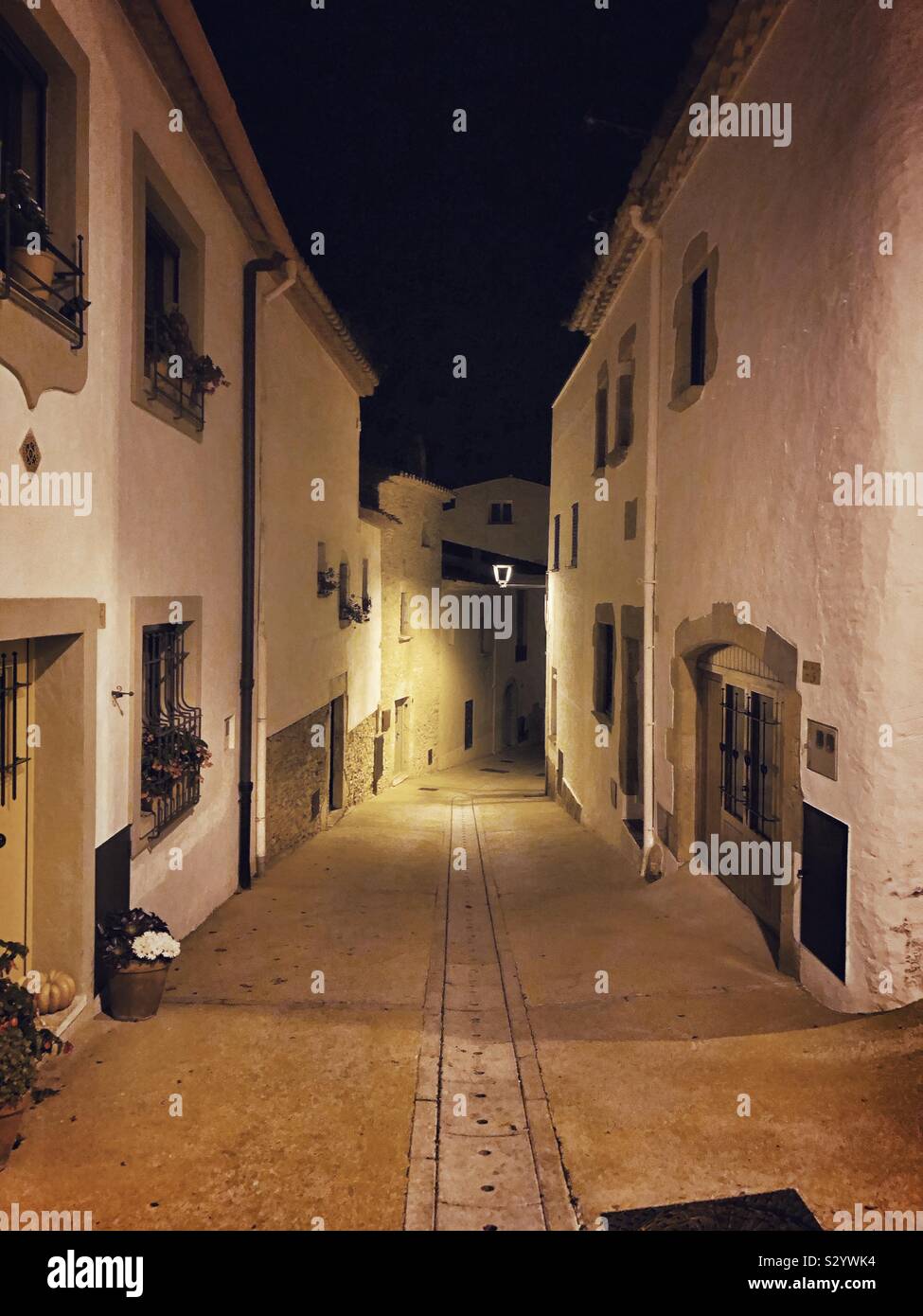 A typical street in Begur, Spain, at a quiet night time and no people around. - Smartphone Captured Stock Image