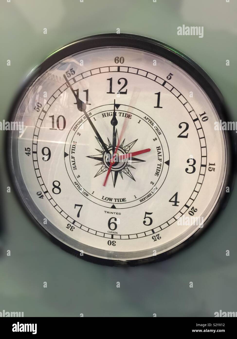 Time and tide information on display. Concepts: time and tide wait for nobody. Five minutes to midnight? - Smartphone Captured Stock Image