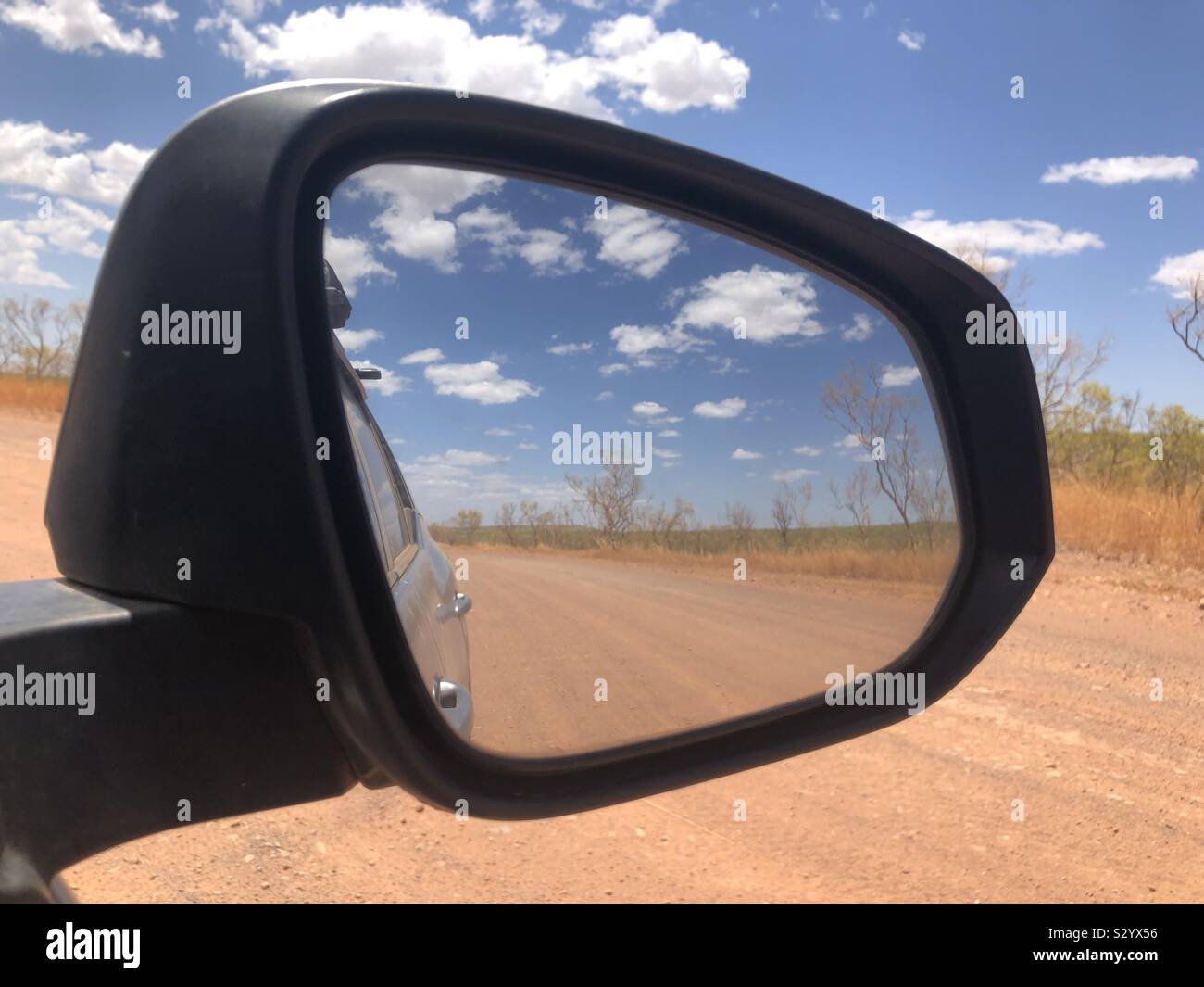 View of the Australian outback through a car wing mirror - Smartphone Captured Stock Image