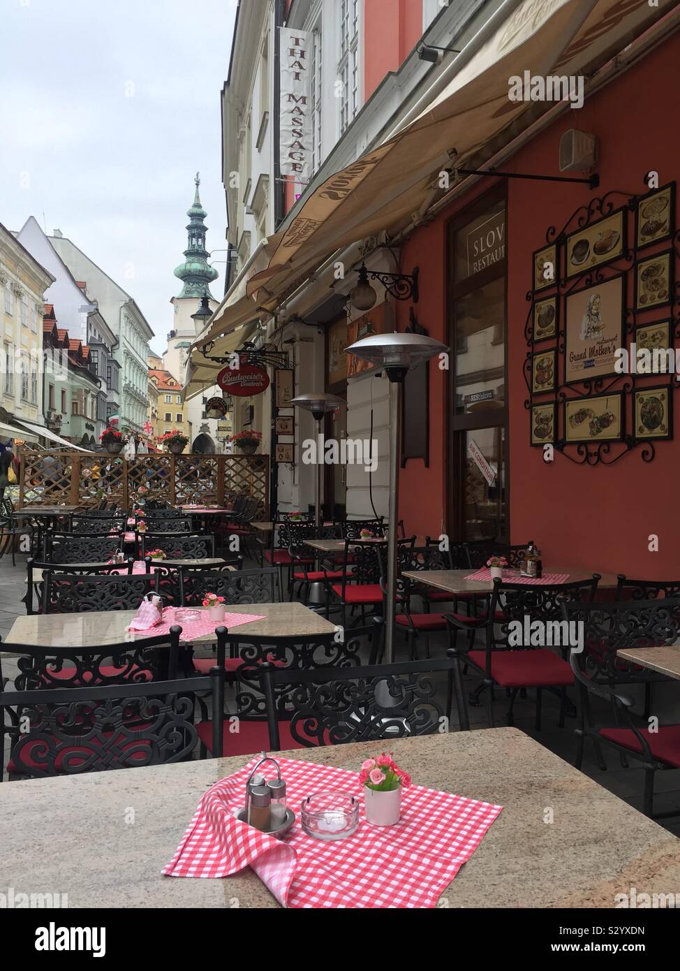 Traditional Slovakian restaurant in the European capital city of Bratislava. Church’s steeple in the background. - Smartphone Captured Stock Image