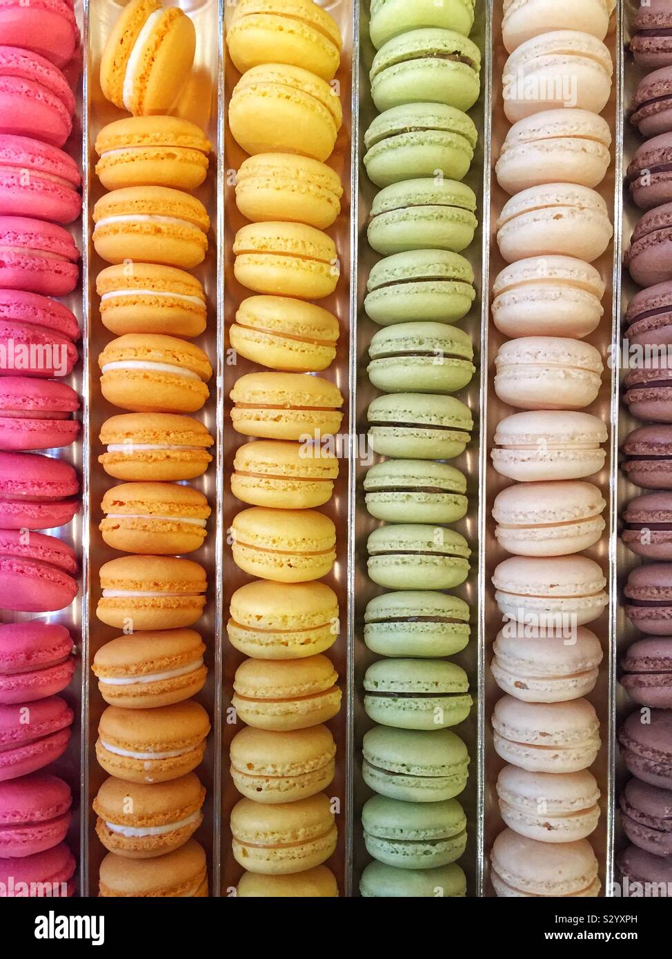 A full frame background of rows of colourful macarons and macaroons in a bakery with copy space - Smartphone Captured Stock Image